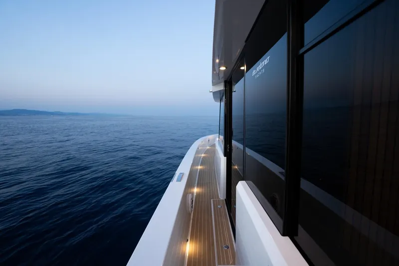 Slide: The Image of 2026 De Antonio Yachts D60 cruising on calm ocean waters at dusk. - 20