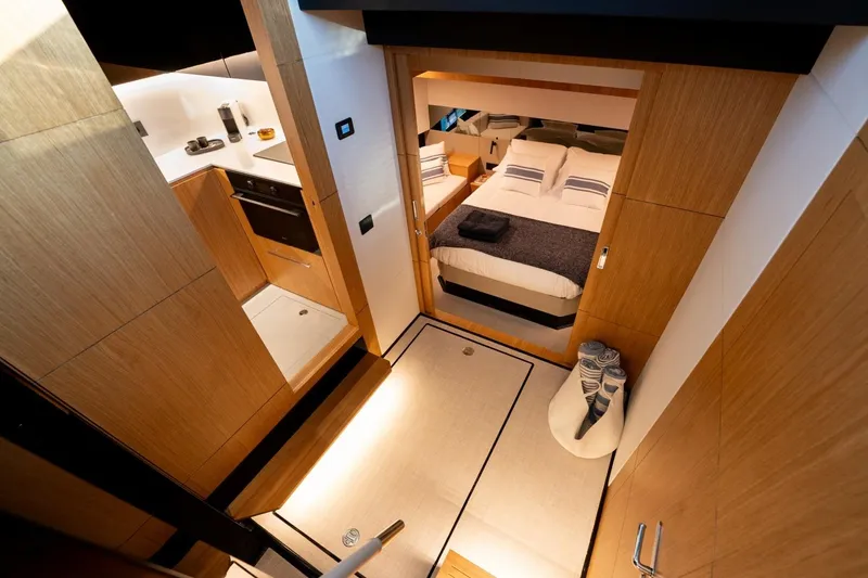 Slide: The Image of Luxurious interior of 2026 De Antonio Yachts D60, featuring modern kitchen and cozy bedroom. - 23