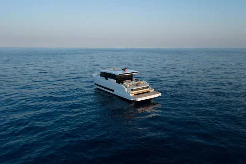 Slide: The Image of 2026 De Antonio Yachts D60 cruising on open sea under clear sky. - 5