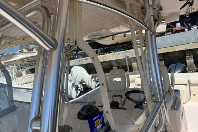 Slide: The Image of 2007 Grady-White Bimini 306 boat interior with steering wheel and seating, docked at marina. - 11