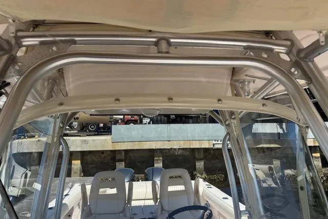 Slide: The Image of 2007 Grady-White Bimini 306 boat interior with seating and helm, docked at marina. - 12