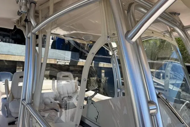Slide: The Image of 2007 Grady-White Bimini 306 boat interior with seating and metal framework. - 13