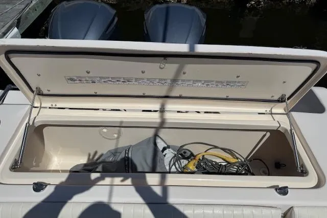 Slide: The Image of Open storage compartment on 2007 Grady-White Bimini 306 boat, showing equipment inside. - 14