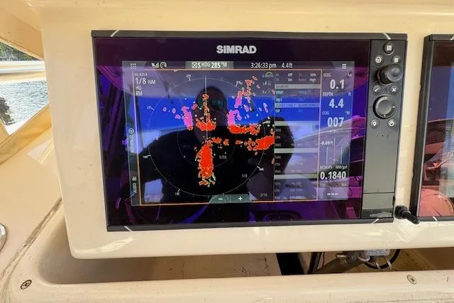 Slide: The Image of Simrad marine navigation display on 2007 Grady-White Bimini 306 boat, showing radar and data. - 18