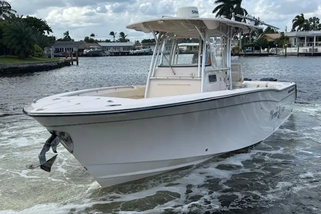 Slide: The Image of 2007 Grady-White Bimini 306 boat cruising on a scenic waterway. - 2