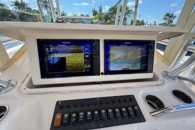 Slide: The Image of 2007 Grady-White Bimini 306 boat dashboard with dual Simrad displays and control panel. - 20