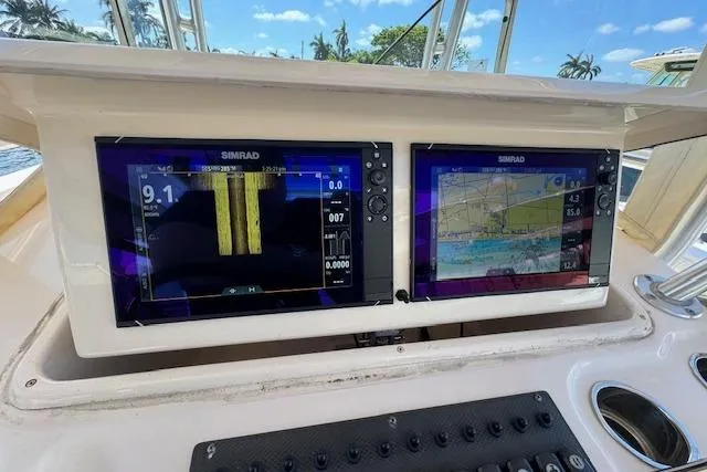 Slide: The Image of 2007 Grady-White Bimini 306 boat dashboard with dual Simrad navigation screens. - 21