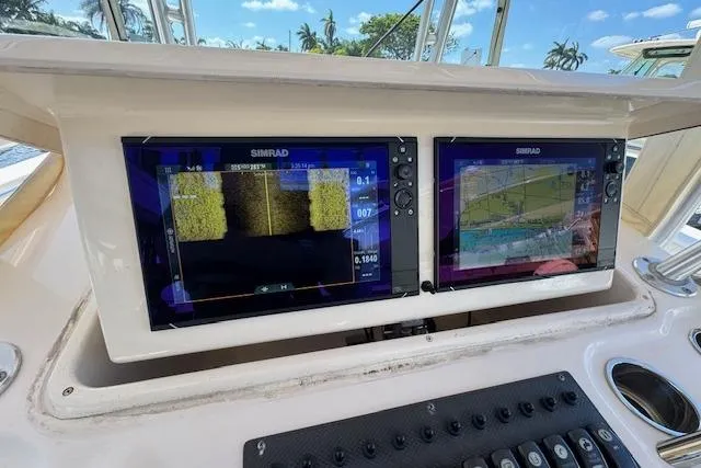 Slide: The Image of Dual Simrad displays on 2007 Grady-White Bimini 306 boat dashboard. - 22