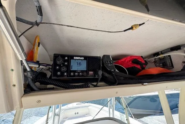 Slide: The Image of 2007 Grady-White Bimini 306 boat interior with Simrad marine radio and safety equipment. - 25