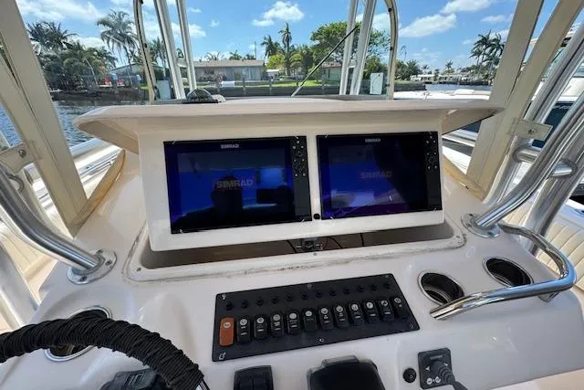 Slide: The Image of 2007 Grady-White Bimini 306 boat dashboard with dual Simrad displays and control panel. - 26