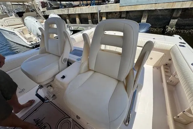 Slide: The Image of 2007 Grady-White Bimini 306 boat with white cushioned seats at dock. - 29