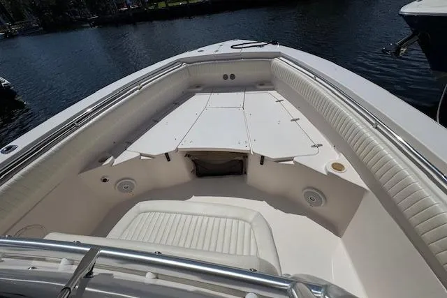 Slide: The Image of 2007 Grady-White Bimini 306 boat interior with cushioned seating and storage compartments. - 33