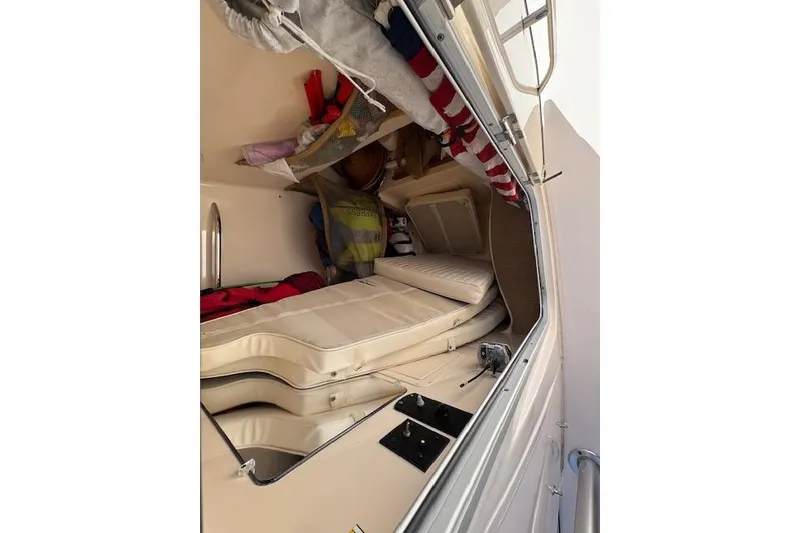 Slide: The Image of 2007 Grady-White Bimini 306 cabin interior with cushions and storage items. - 34