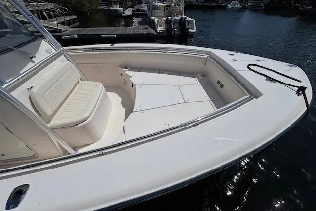 Slide: The Image of 2007 Grady-White Bimini 306 boat with spacious seating, docked by the water. - 39