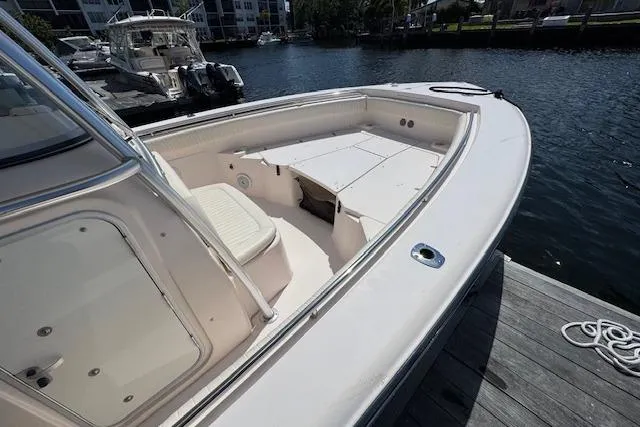 Slide: The Image of 2007 Grady-White Bimini 306 boat docked, showcasing spacious deck and seating area. - 40
