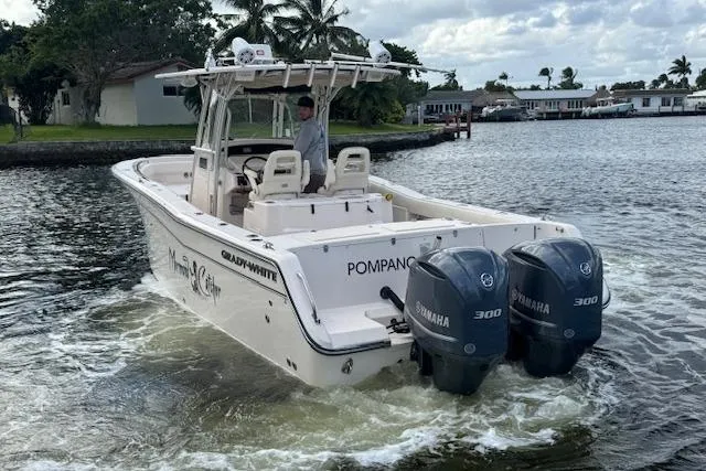 Slide: The Image of 2007 Grady-White Bimini 306 boat with twin Yamaha 300 engines on a calm waterway. - 6
