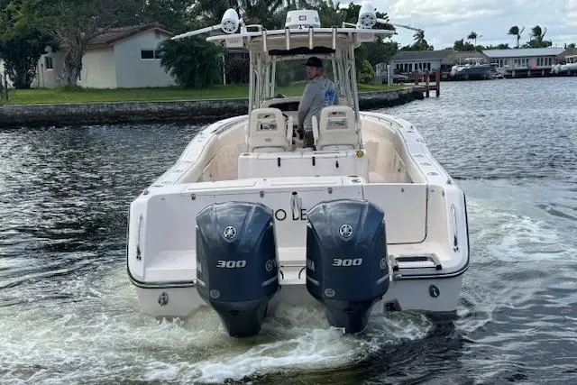 Slide: The Image of 2007 Grady-White Bimini 306 boat with dual 300 engines cruising on a waterway. - 7
