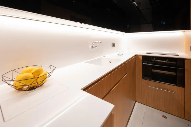 Slide: The Image of Modern kitchen interior on 2026 De Antonio Yachts D60, featuring sleek design and wooden cabinetry. - 27