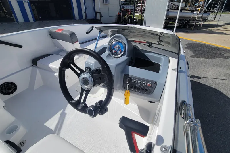 Slide: The Image of Interior of 2022 Tahoe T16 boat showing steering wheel and dashboard controls. - 11