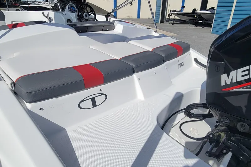 Slide: The Image of 2022 Tahoe T16 boat with red and gray seating, featuring a Mercury engine. - 6