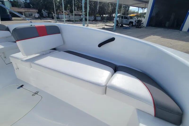 Slide: The Image of 2022 Tahoe T16 boat interior with white and gray seating, red accents. - 9