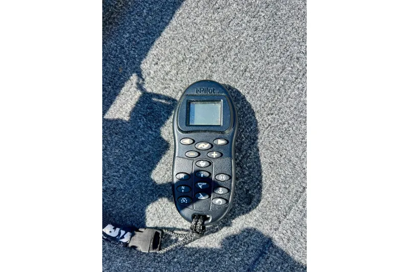 Slide: The Image of Remote control on MirroCraft 2004 1876 Outfitter boat, resting on gray carpet. - 10