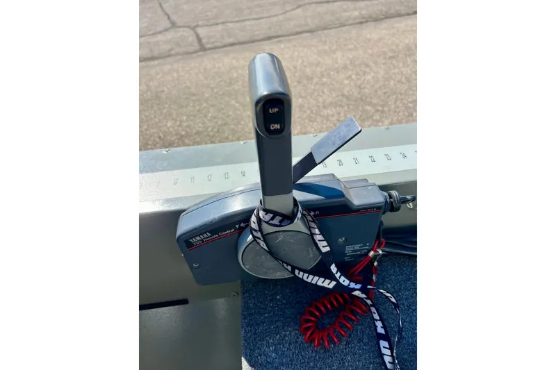 Slide: The Image of Yamaha throttle control on 2004 MirroCraft 1876 Outfitter boat, featuring lanyard and ruler. - 11