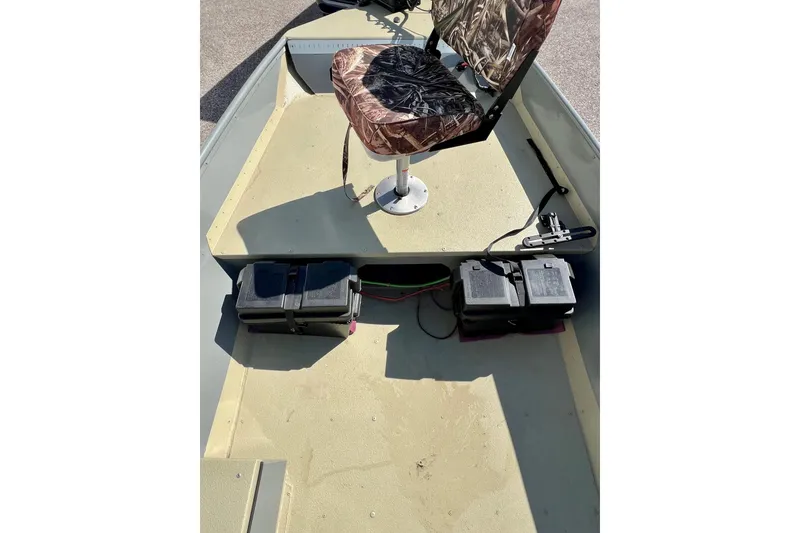 Slide: The Image of 2004 MirroCraft 1876 Outfitter boat interior with camo seat and battery compartments. - 13