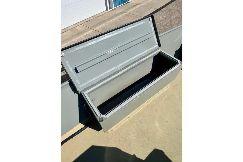 Slide: The Image of Open storage compartment on 2004 MirroCraft 1876 Outfitter boat. - 16