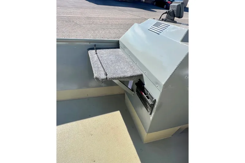 Slide: The Image of 2004 MirroCraft 1876 Outfitter boat interior with storage compartment and carpeted surface. - 20