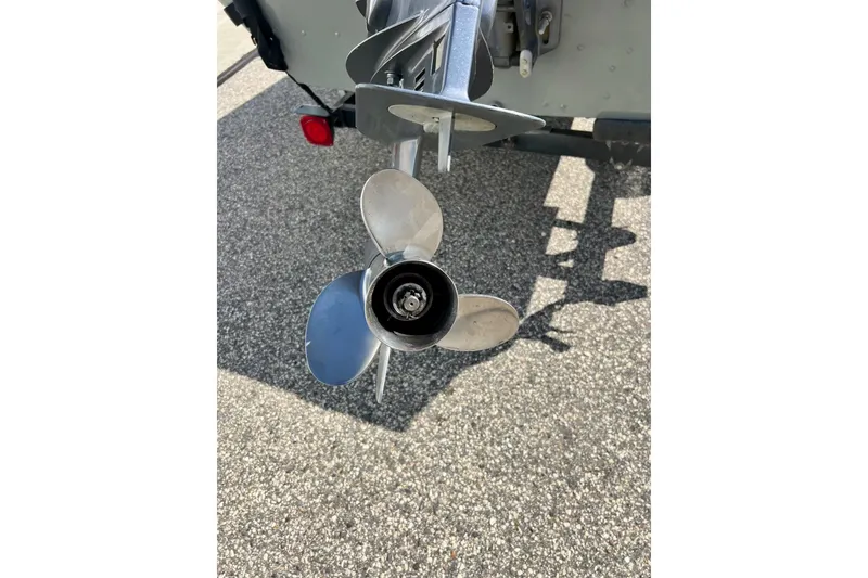 Slide: The Image of Propeller of 2004 MirroCraft 1876 Outfitter boat on asphalt surface. - 7