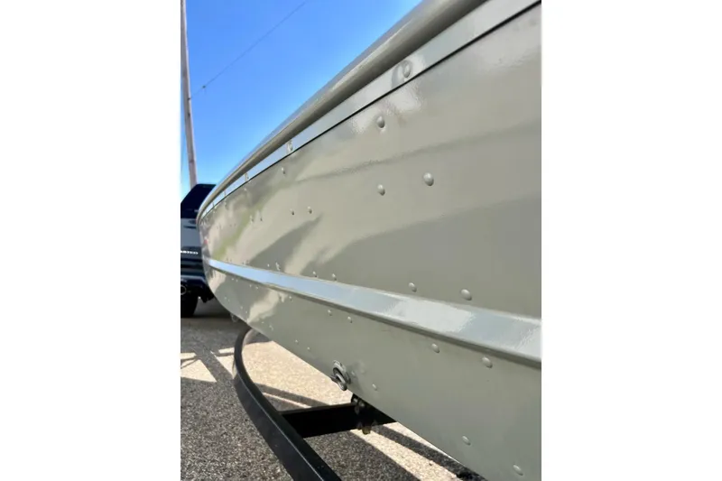 Slide: The Image of 2004 MirroCraft 1876 Outfitter boat side view, showing riveted aluminum hull. - 8