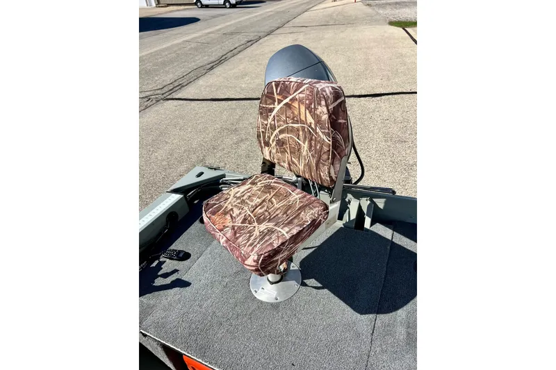 Slide: The Image of Camouflage seat on 2004 MirroCraft 1876 Outfitter boat, parked on pavement. - 9