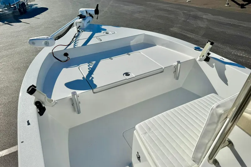 Slide: The Image of 2024 Lookout Bay 19 boat interior with seating and fishing rod holders. - 10