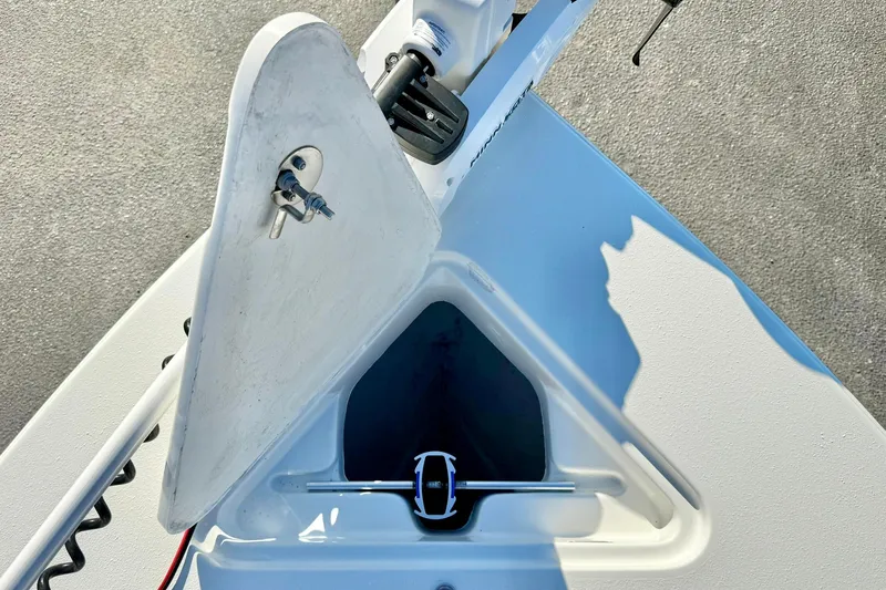 Slide: The Image of 2024 Lookout Bay 19 boat anchor compartment with open hatch and visible anchor. - 11