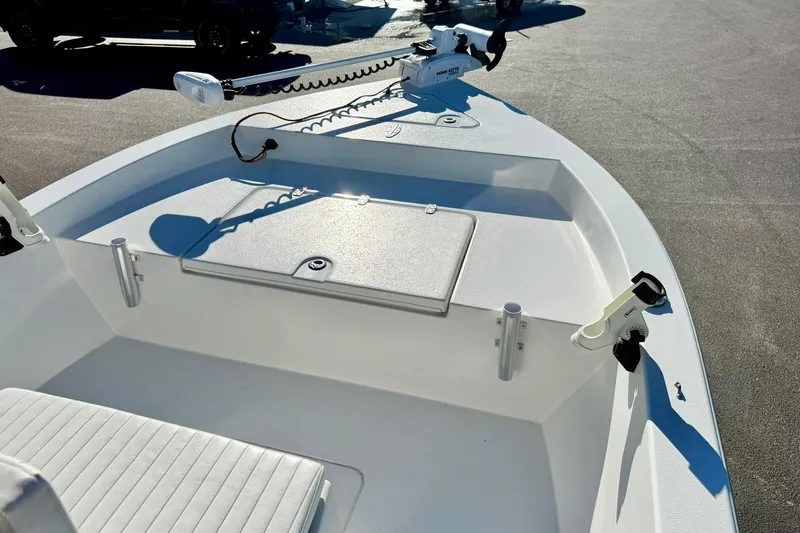 Slide: The Image of 2024 Lookout Bay 19 boat interior with fishing rod holders and storage compartment. - 14