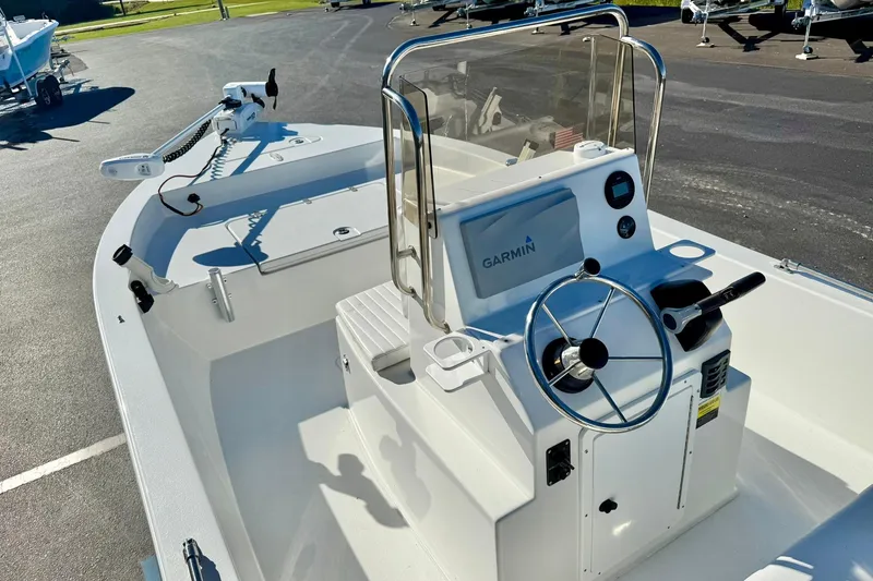 Slide: The Image of 2024 Lookout Bay 19 boat with Garmin navigation, steering wheel, and control panel. - 22