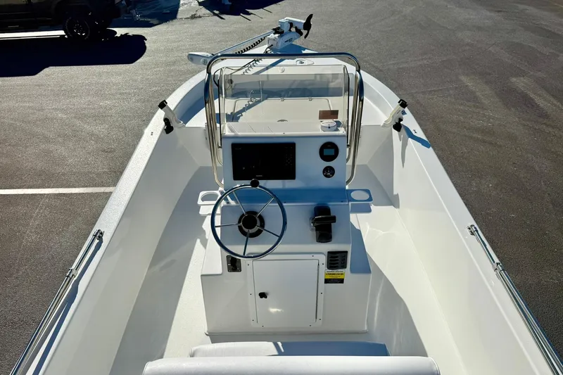Slide: The Image of 2024 Lookout Bay 19 boat interior with steering wheel and control panel. - 24