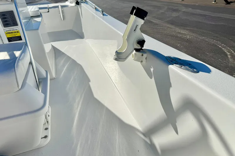 Slide: The Image of 2024 Lookout Bay 19 boat interior with rod holder and seating. - 29