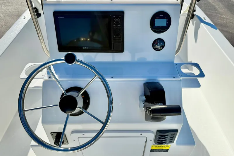 Slide: The Image of 2024 Lookout Bay 19 boat dashboard with steering wheel, Garmin display, and Yamaha controls. - 3