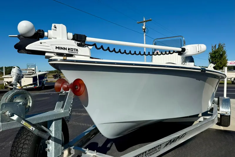 Slide: The Image of 2024 Lookout Bay 19 boat on trailer with Minn Kota Terrova motor, parked outdoors. - 6