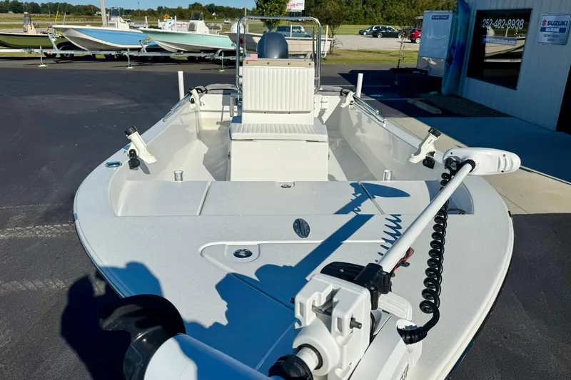 Slide: The Image of 2024 Lookout Bay 19 boat with modern features, displayed outdoors at a dealership. - 9