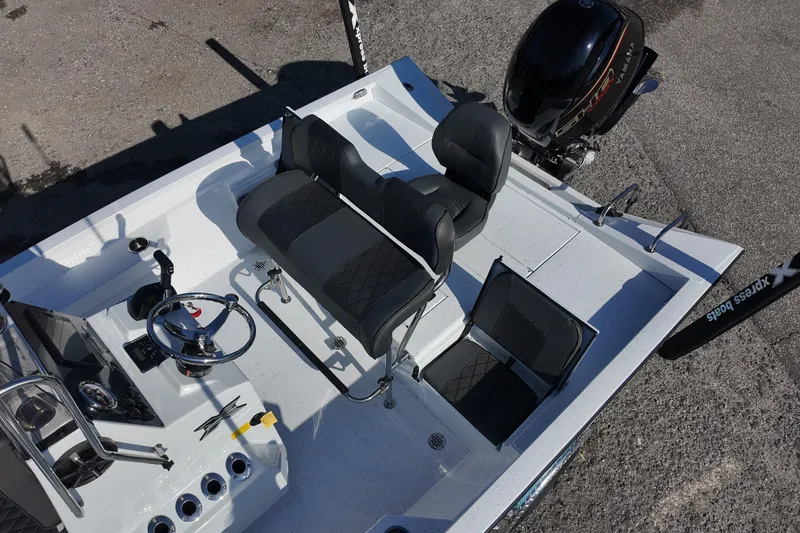Slide: The Image of 2026 Xpress H20B Bay boat interior with seating and steering console. - 11