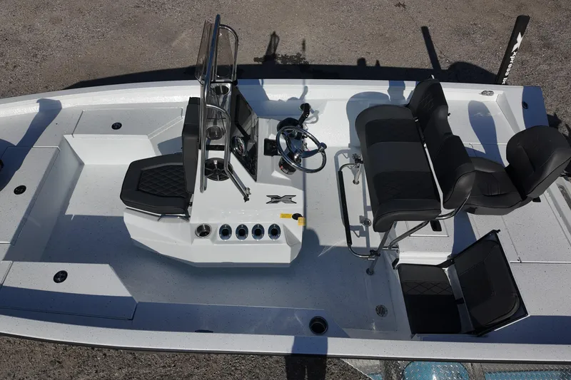 Slide: The Image of 2026 Xpress H20B Bay boat interior with seating and steering console. - 17