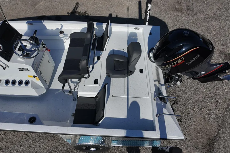 Slide: The Image of 2026 Xpress H20B Bay boat interior with Yamaha engine, featuring seating and steering console. - 18