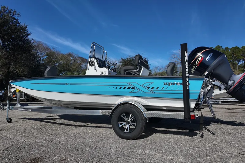 Slide: The Image of 2026 Xpress H20B Bay boat with Yamaha engine on trailer, parked outdoors. - 3