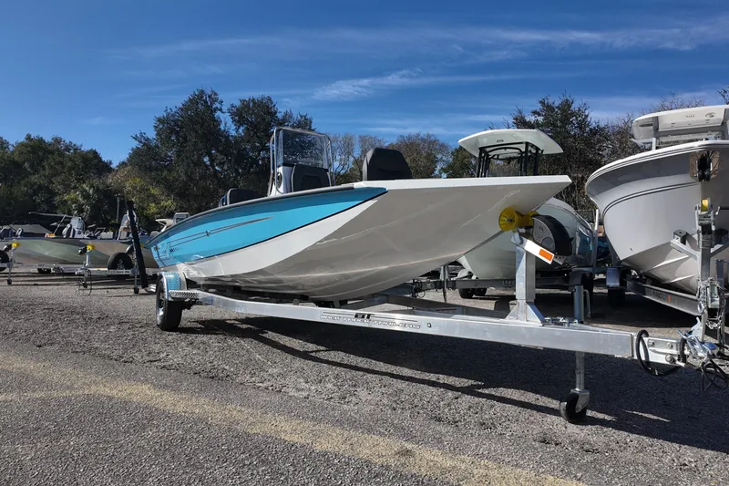 Slide: The Image of 2026 Xpress H20B Bay boat on trailer, parked outdoors under clear sky. - 4