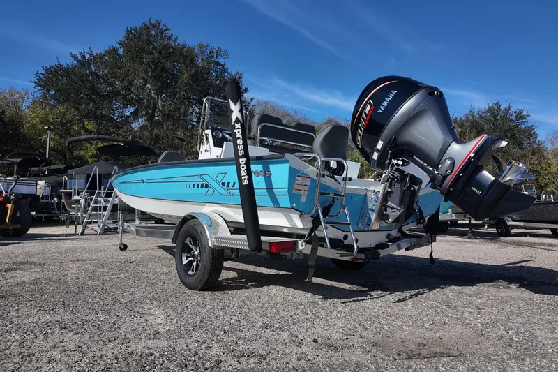 Slide: The Image of 2026 Xpress H20B Bay boat with Yamaha engine on trailer, parked outdoors. - 5