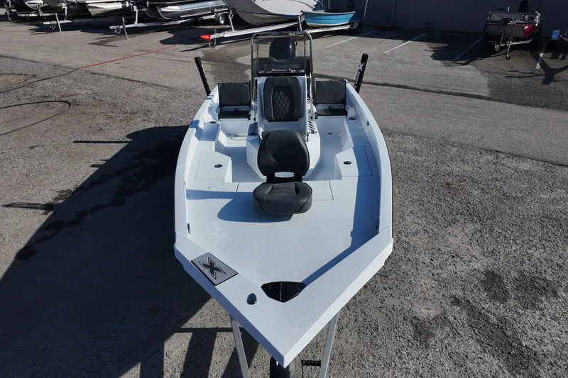 Slide: The Image of 2026 Xpress H20B Bay boat in a parking lot, showcasing sleek design and seating arrangement. - 9