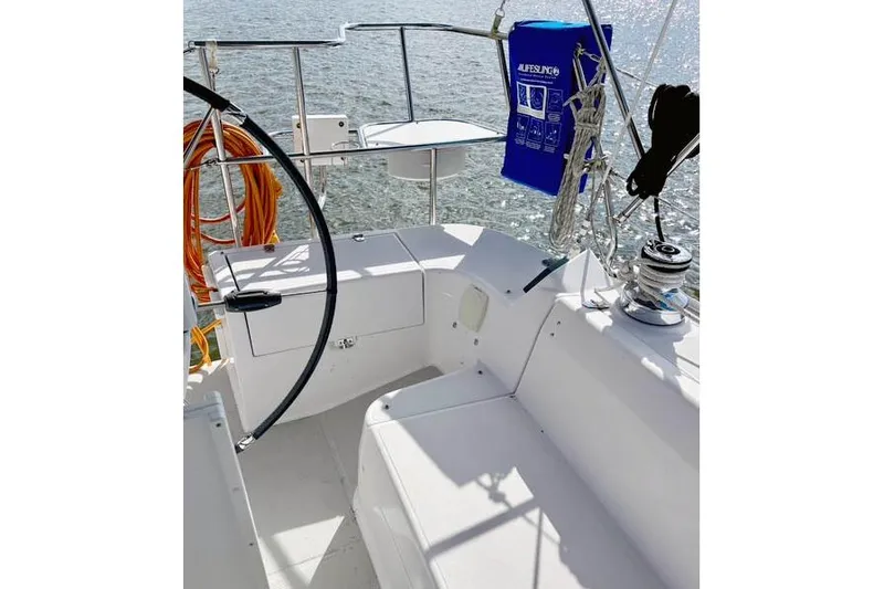 Slide: The Image of 2017 Catalina boat cockpit with steering wheel, seating, and safety equipment on a sunny day. - 10